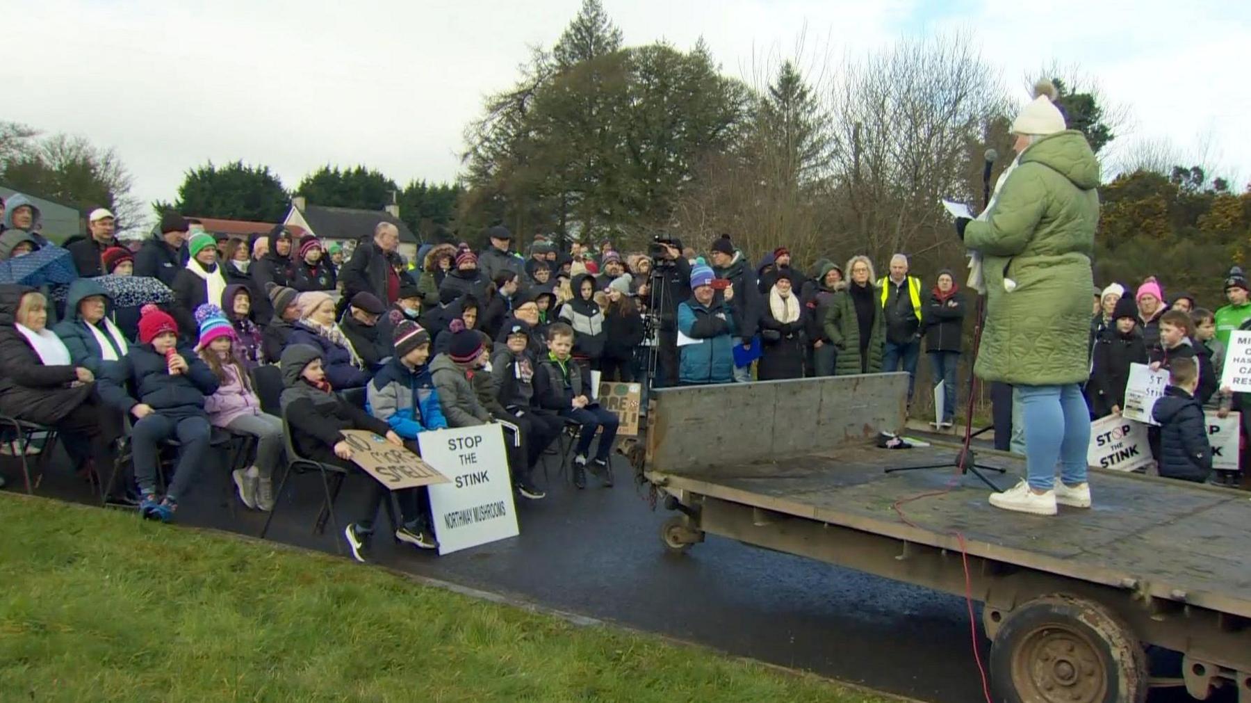 a protest at Northway Mushrooms earlier, in which one protester holds a sign ready "stop the stink"