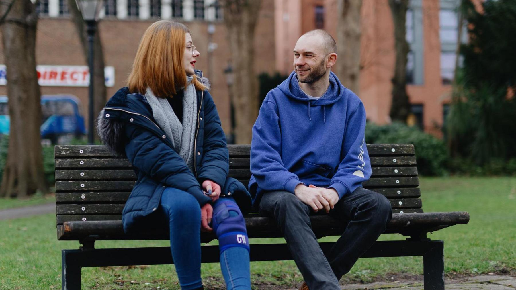 Tara and James sat on a bench talking.