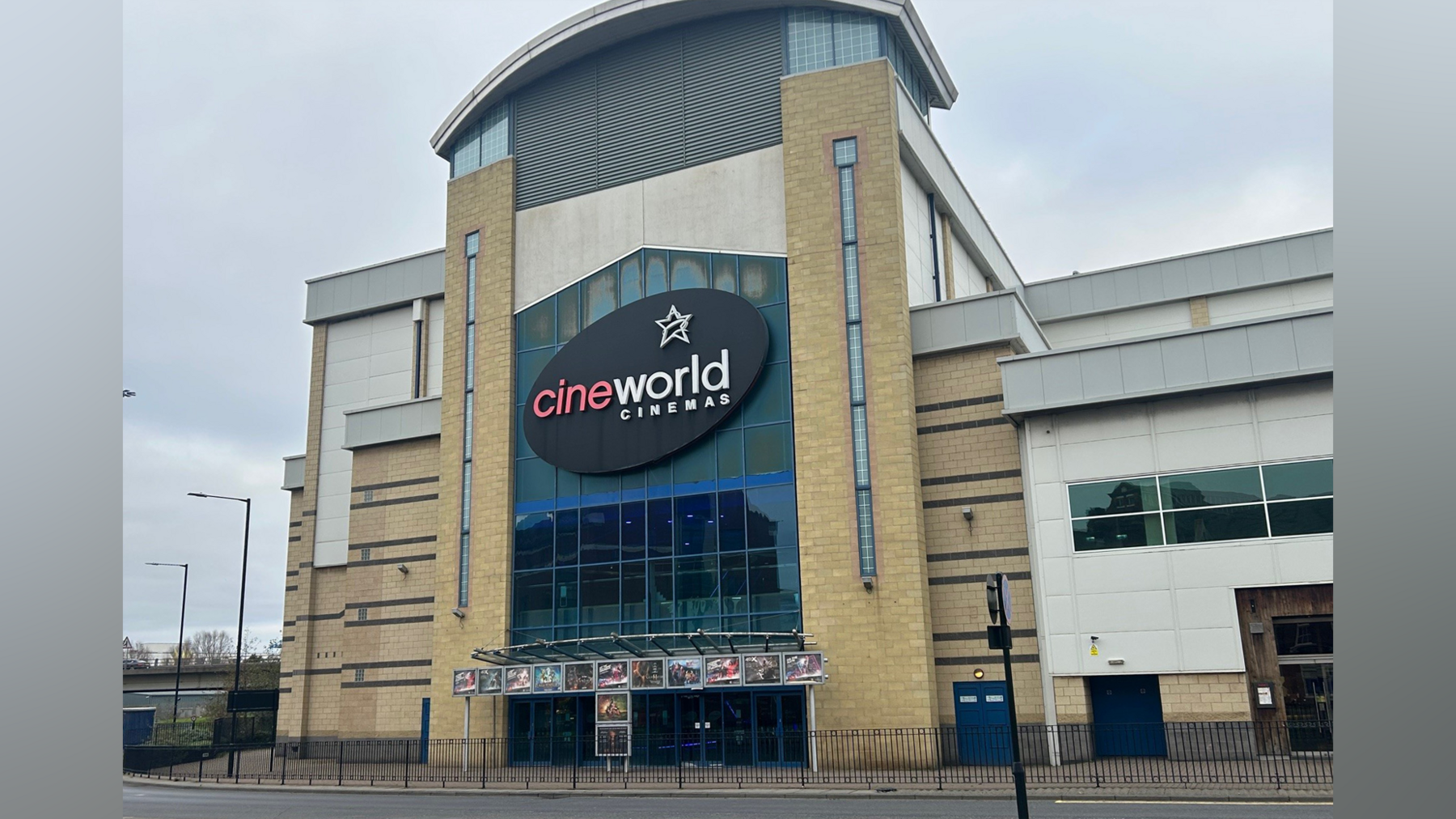 The Cineworld in Middlesbrough is a four-storey light brown brick building. The black sign at the front reads: "Cineworld Cinemas". Underneath are posters with various movies advertised.