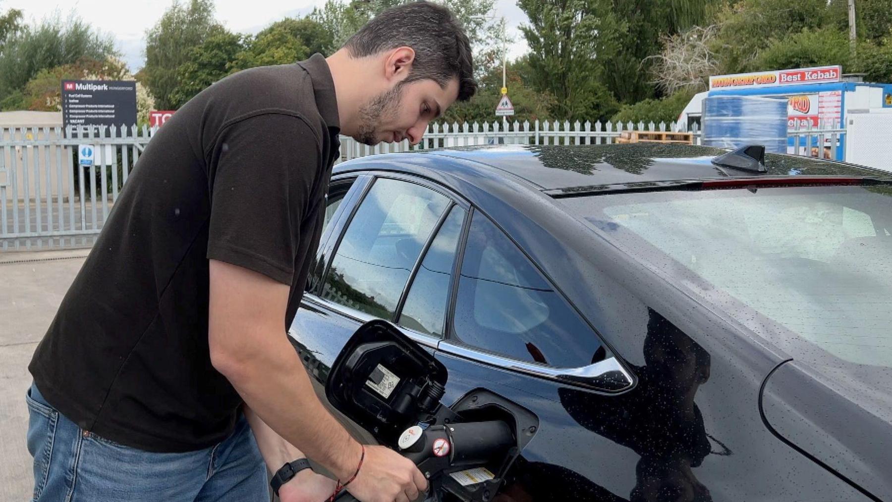 A man puts hydrogen into a fuel cell powered vehicle from one of the trial dispensers at Fuel Cell Systems site at Hungerford.