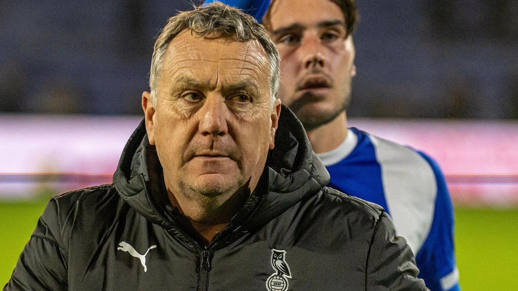 Oldham Athletic boss Micky Mellon looks on