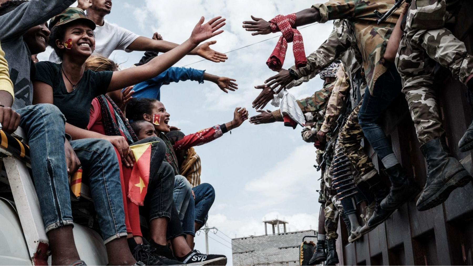 TPLF supports on a bus reach out to touch hands with Tigray soldiers in Mekelle, Tigray - 2021