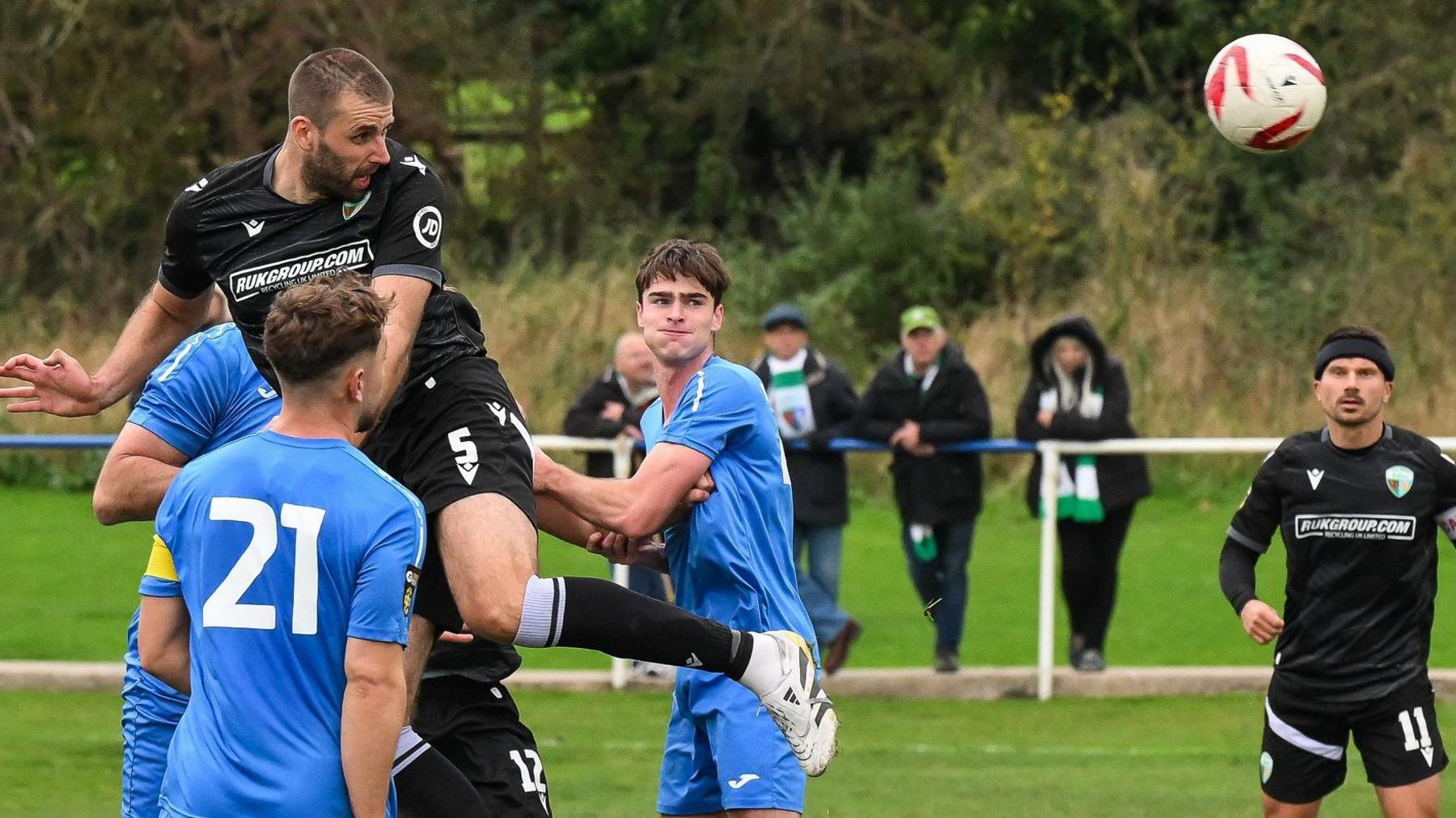 TNS' Ryan Astle heading the ball.