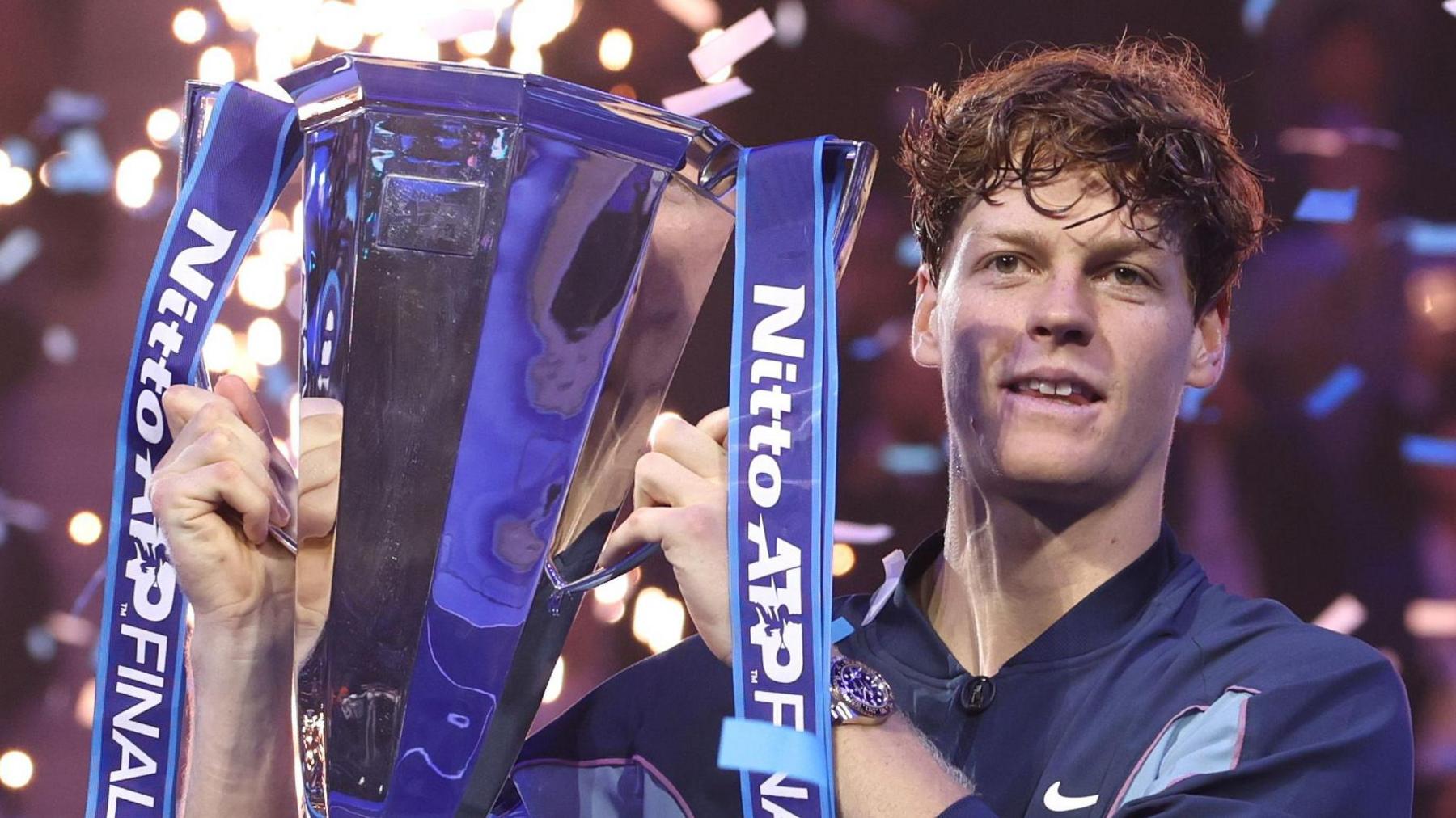 Jannik Sinner celebrates with the ATP Finals trophy