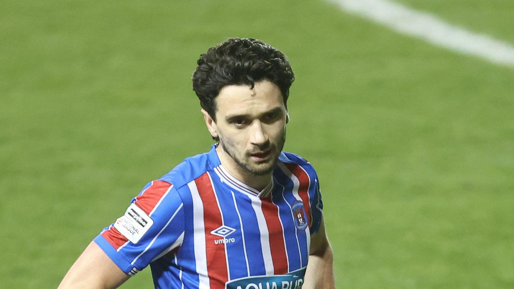 Carlisle player Alex Gilliead stands with his hands on his hips during a match