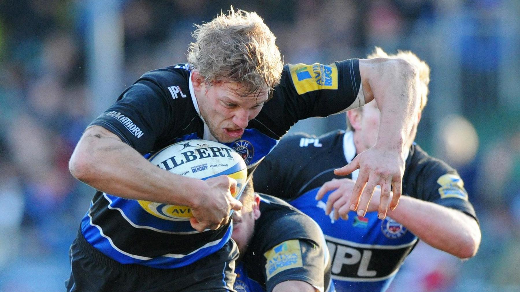 Image of Lewis Moody mid run on the rugby pitch. He's wearing the Blue and Black rugby kit and running with the ball. 