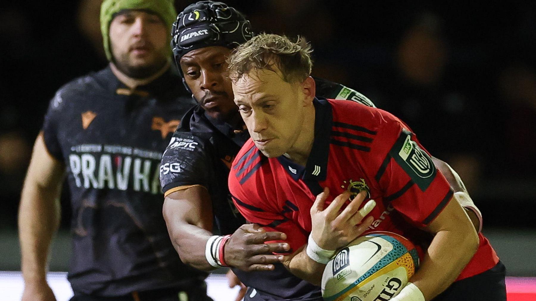 Mike Haley is tackle by Daniel Kasende