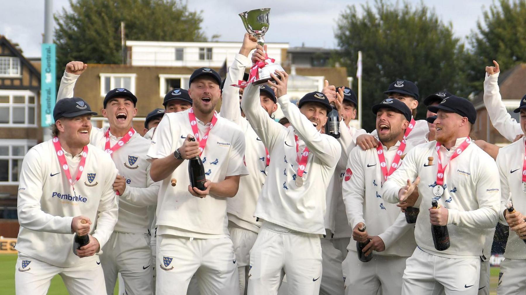 John Simpson holds the Division Two trophy