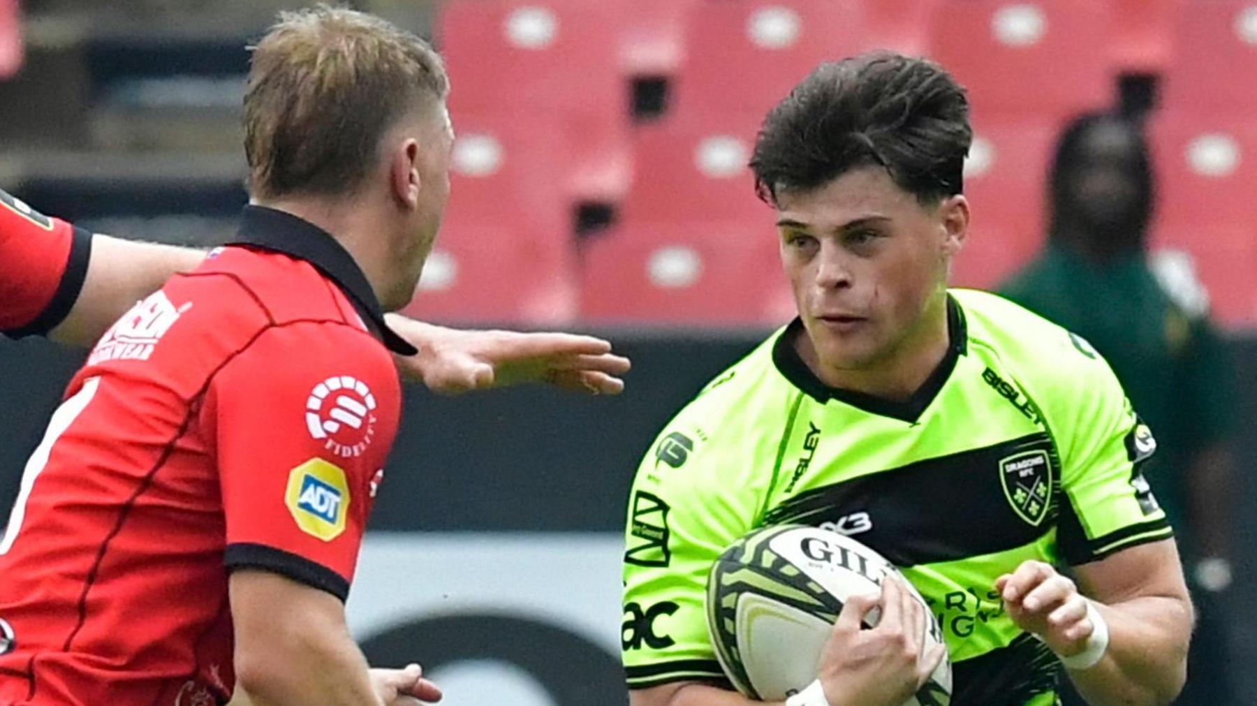 Ewan Rosser of Dragons RFC takes on Morne van den Berg of Emirates Lions