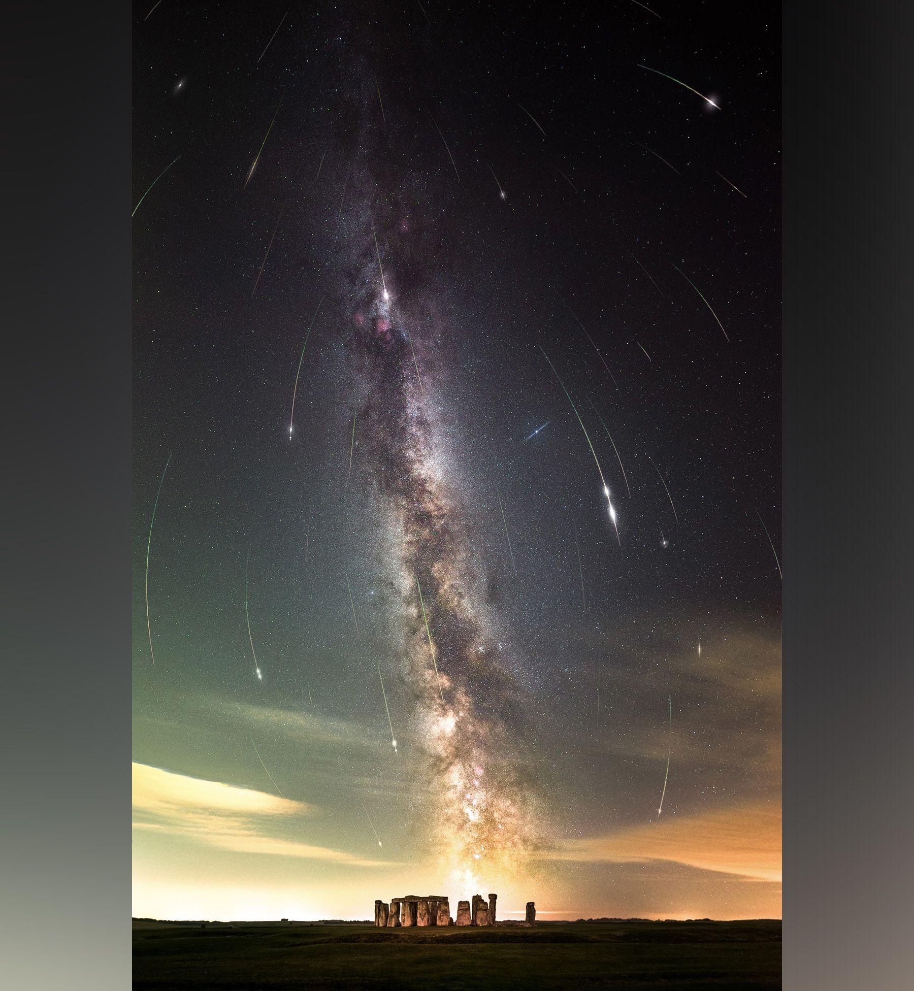 A layered composite image shows several meteor streaks in the night sky over Stonehenge in Wiltshire on 11 August