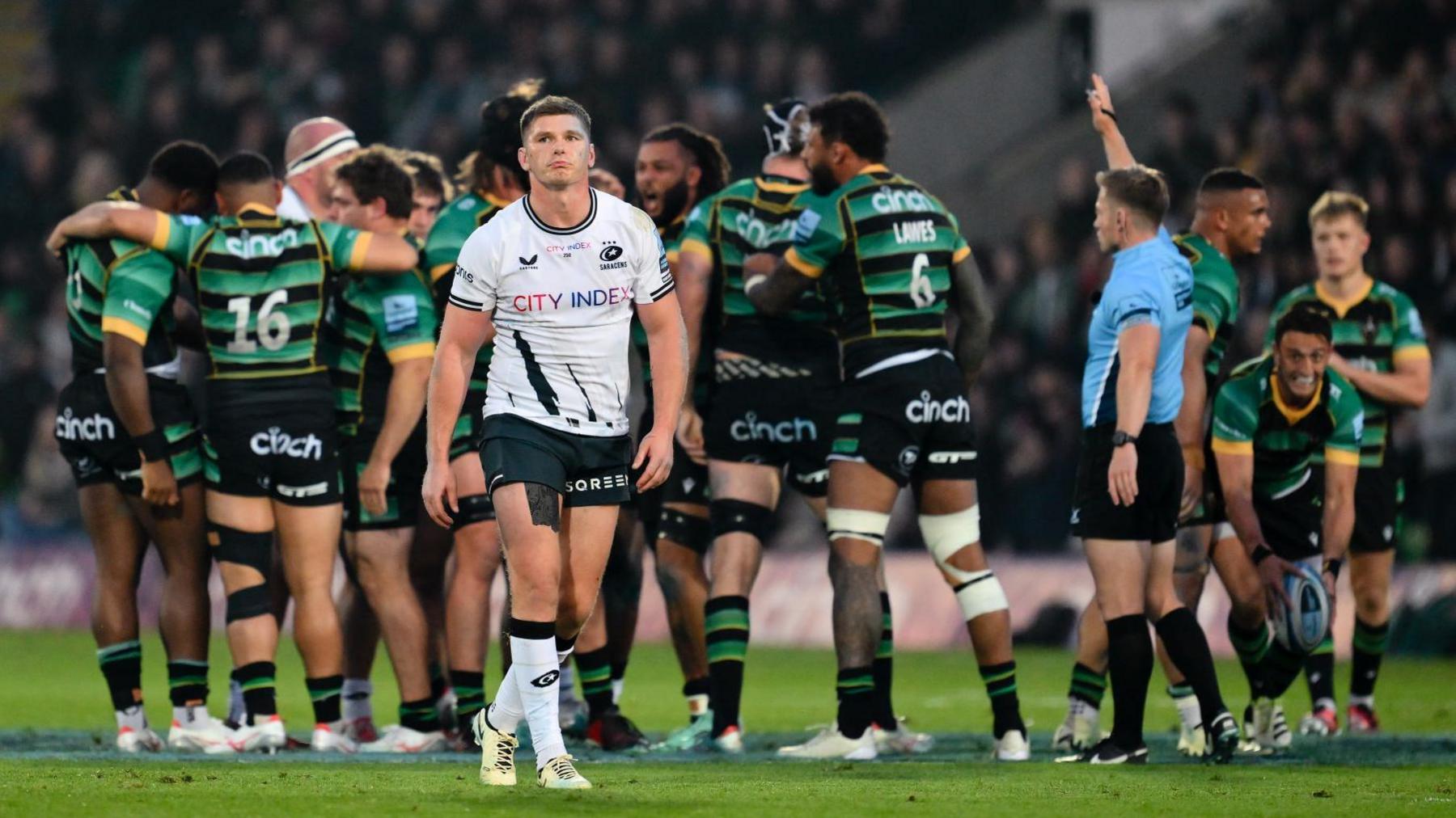 Owen Farrell walks away as Northampton players celebrate