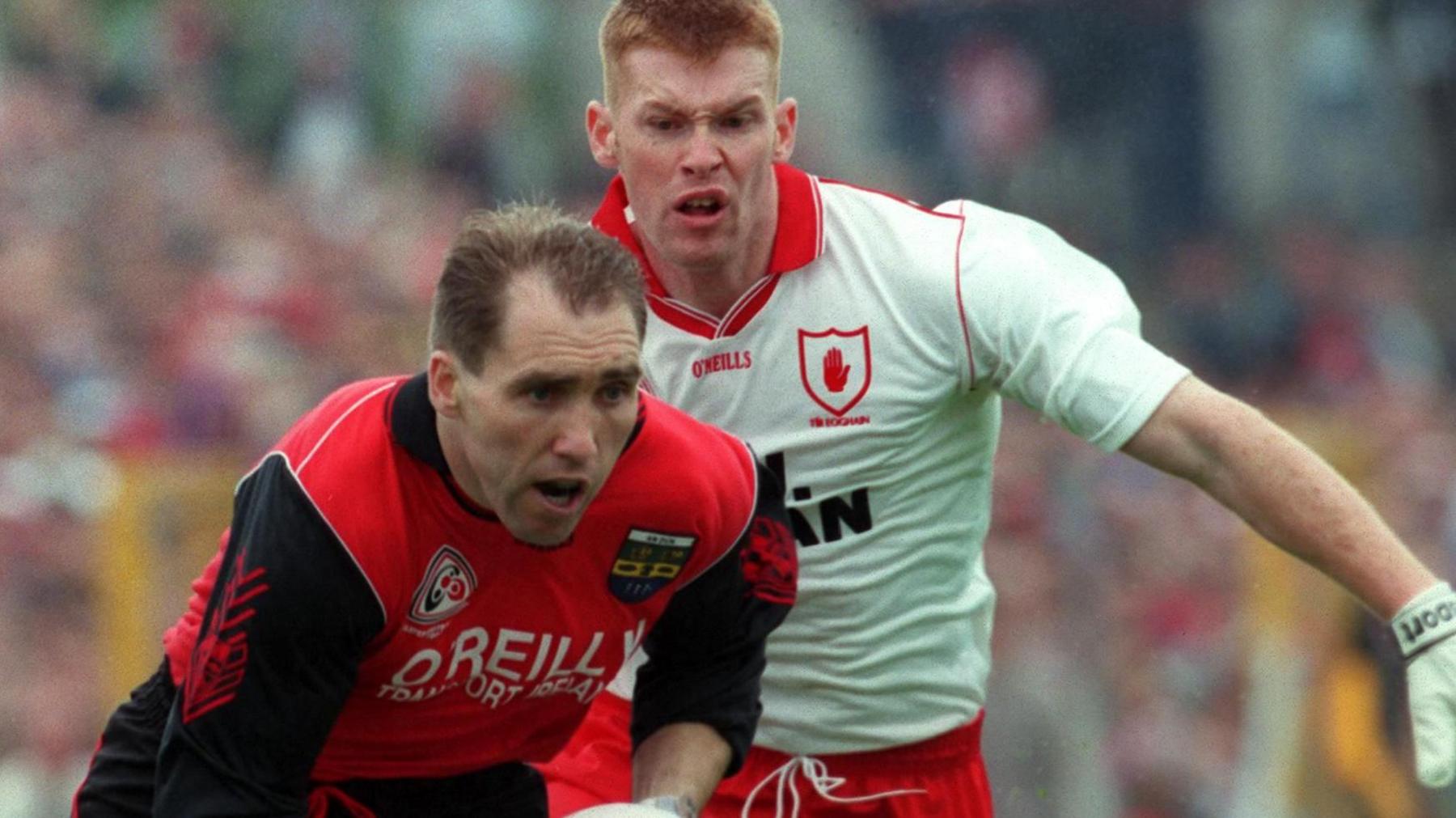 Down's Mickey Linden keeps hold of possession against Tyrone's Jody Gormley in the 1996 Ulster Final