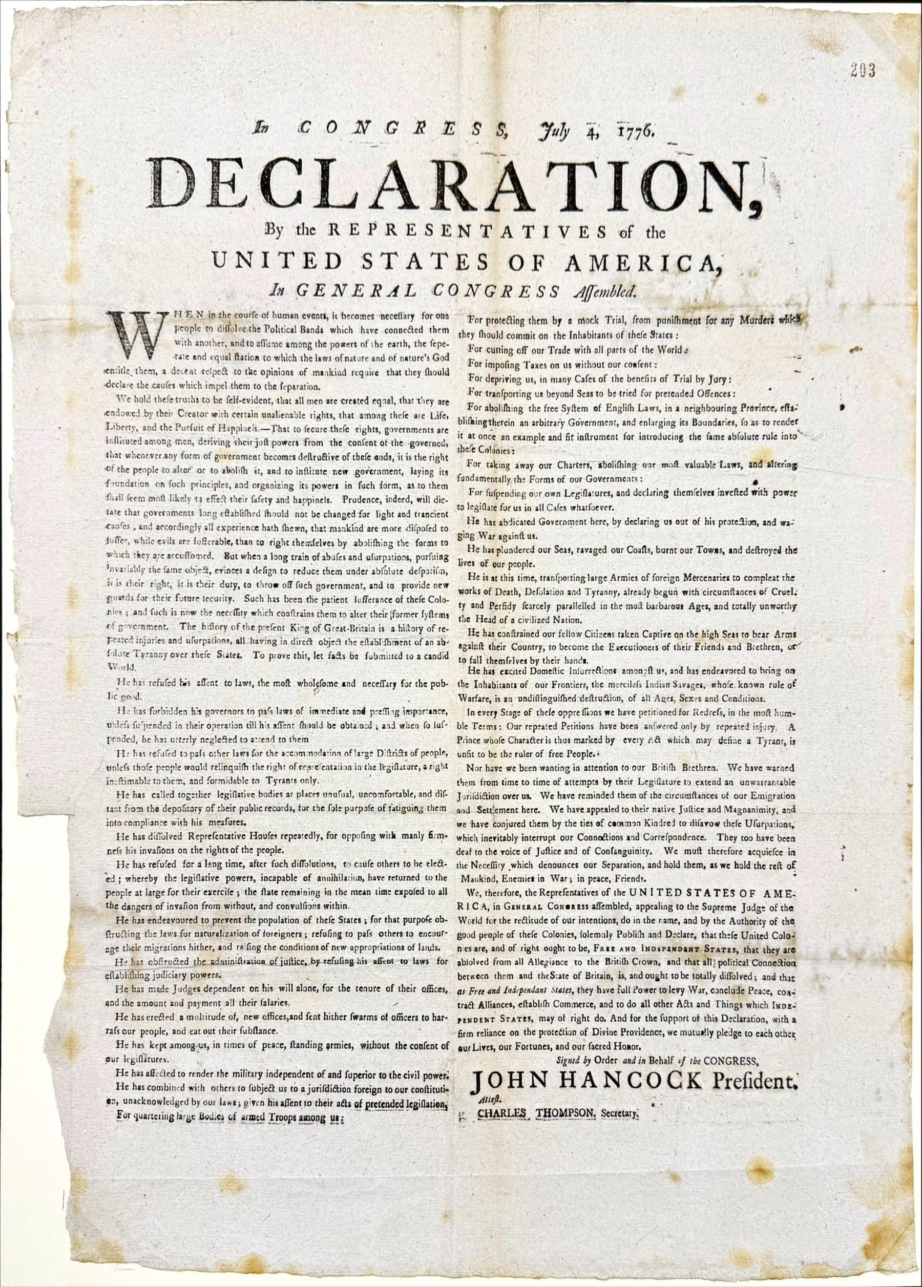A scanned copy of the US Declaration of Independence, with damage in the form of tears and discolouring visible.