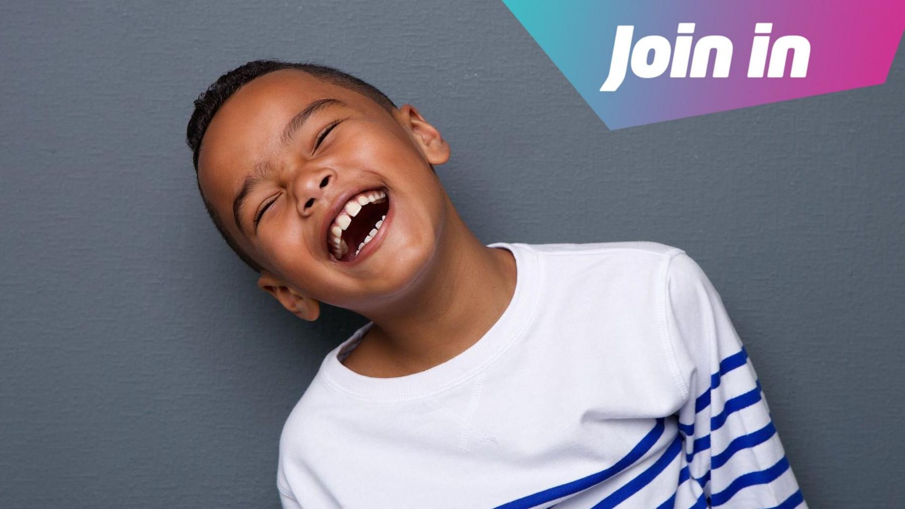 boy in a white striped jumper laughing
