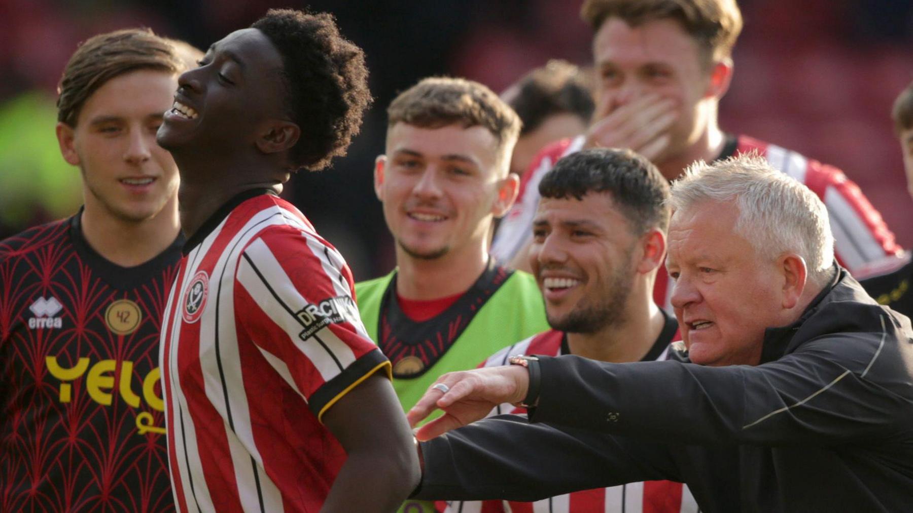 Sheffield United manager Chris Wilder pushes Jesurun Rak-Sakyi towards the fans after their win over Luton Town