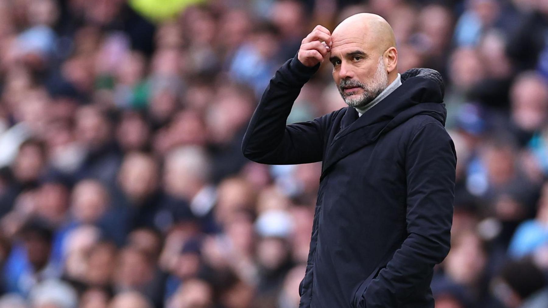 Manchester City boss Pep Guardiola scratches his head