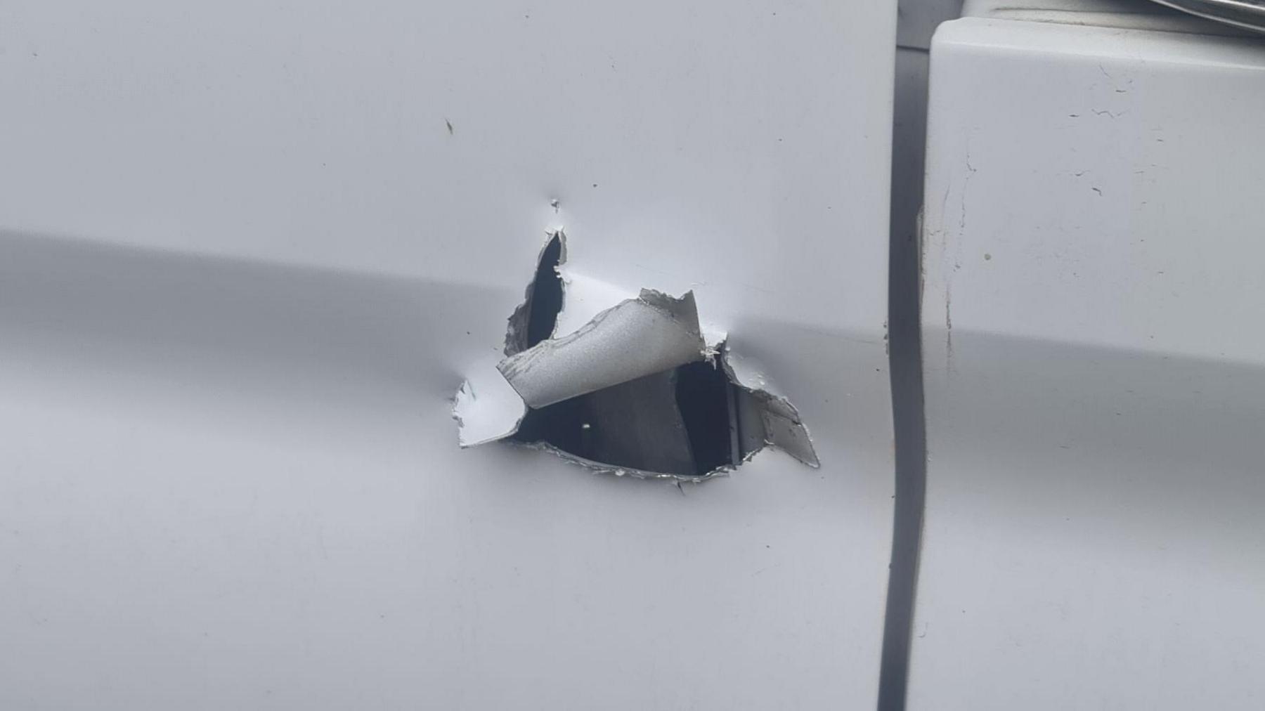 A close-up image shows extensive damage to one of the doors on Mr Kennedy-Hall's van, with a lock roughly cut out.