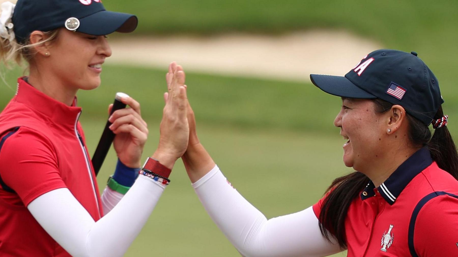 Nelly Korda and Allisen Corpuz high-five after winning their foursomes match on Friday at the Solheim Cup