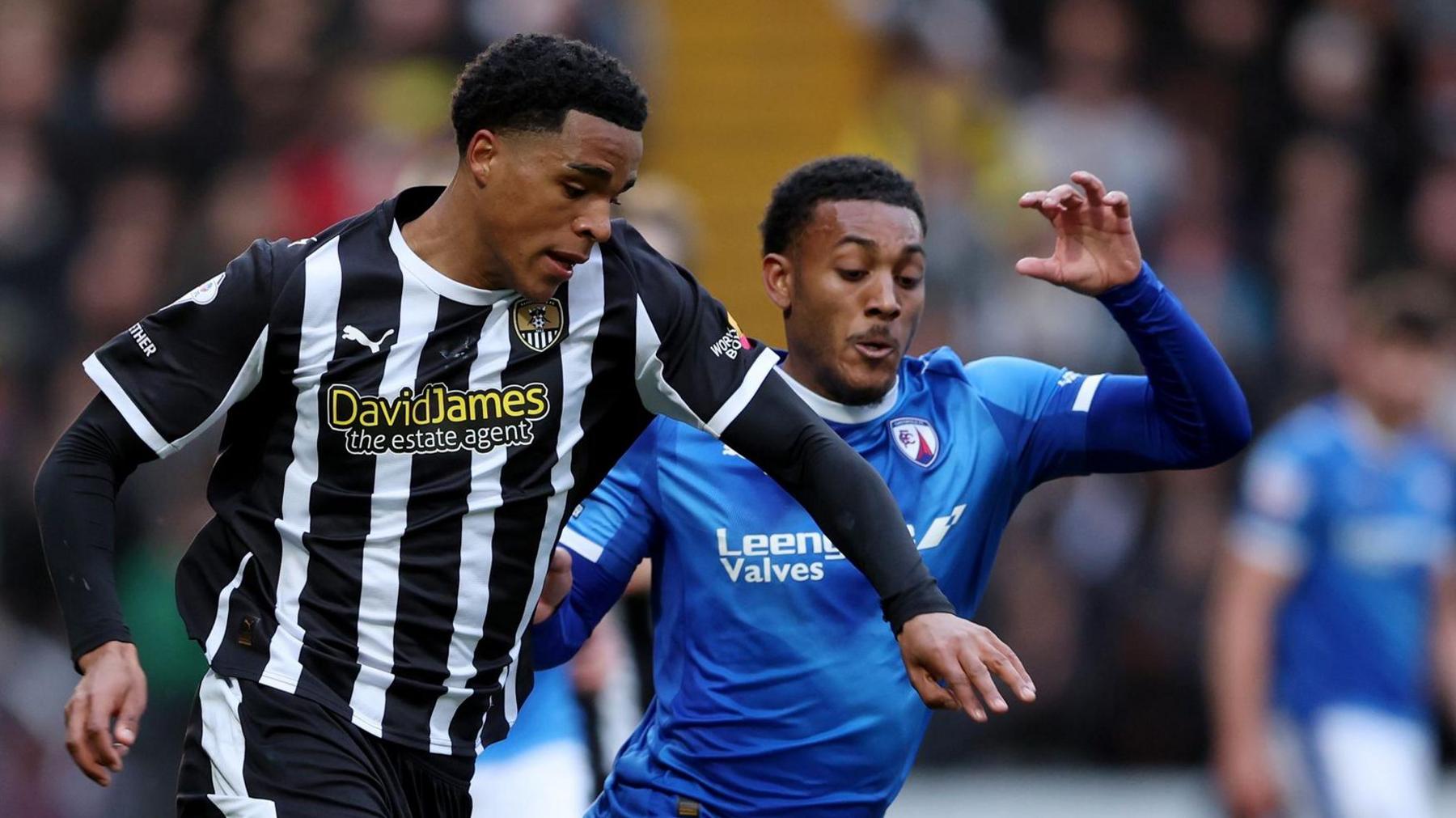 Tom Iorpenda of Notts County runs with the ball while under pressure from Lewis Gordon of Chesterfield 
