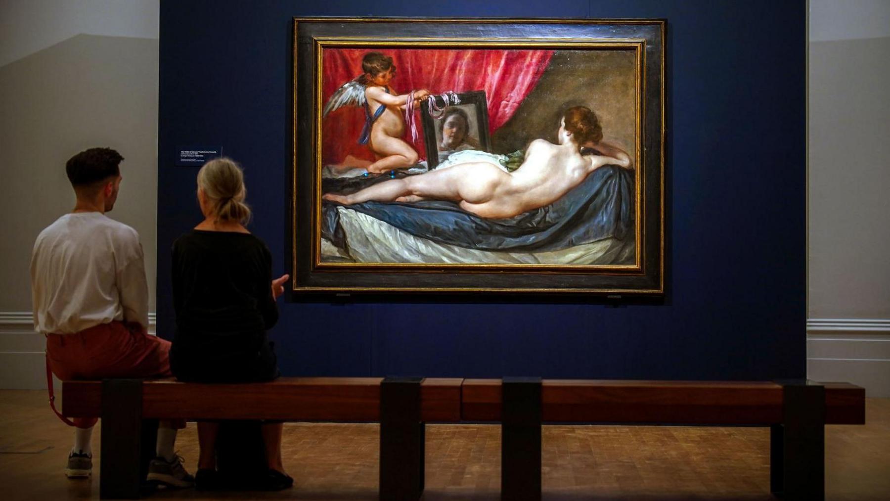 Two people sat in front of Diego Velazquez's The Rokeby Venus at Walker Art Gallery Liverpool