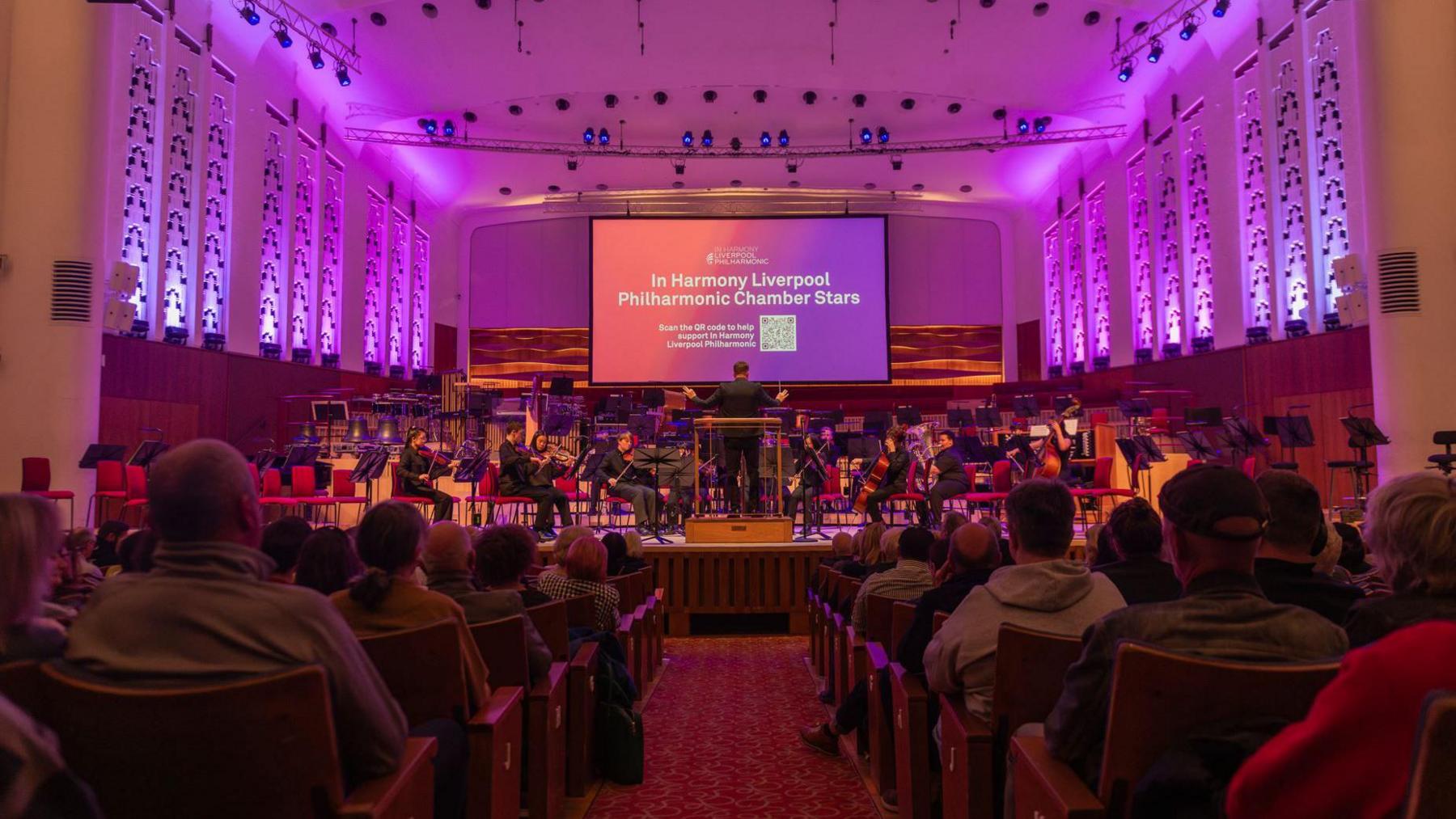 An audience at the Liverpool Philharmonic watching a performance of the In Harmony orchestra