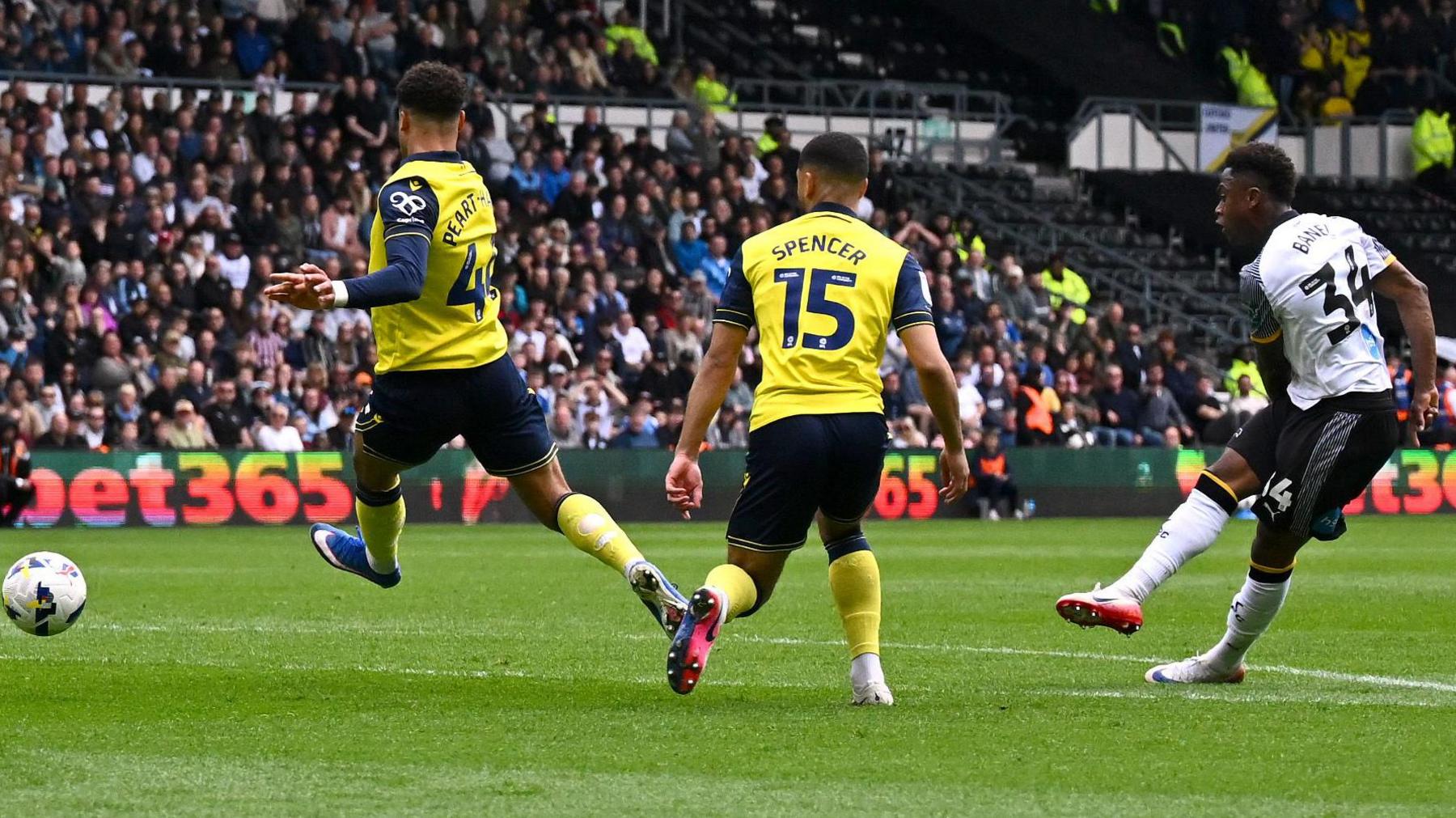 Jaydon Banel (right) scores with a low shot that beats two Oxford United defenders at the top of the box
