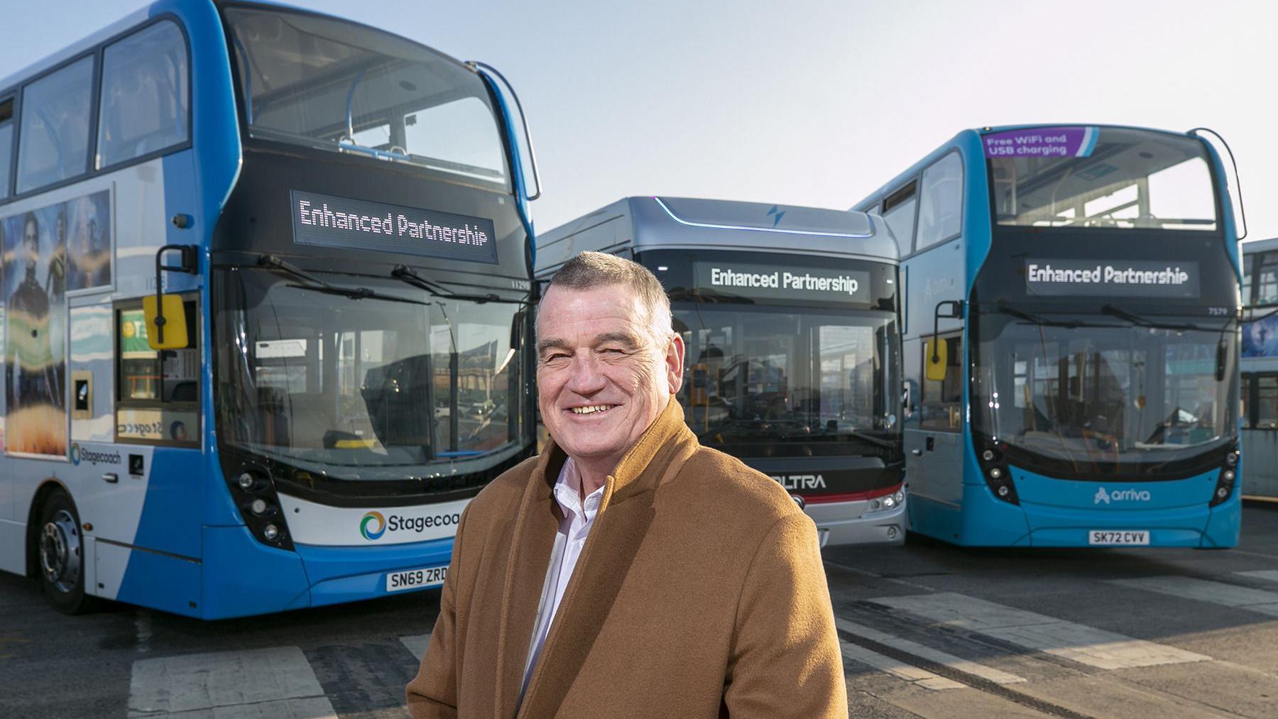 Martin Gannon standing in front of buses