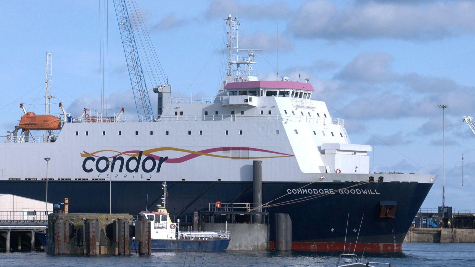 A large Condor Ferries boat stationed at the harbour on a cloudy day.