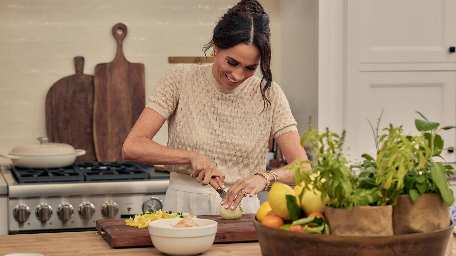 Meghan preparing food in the kitchen in her Netflix series