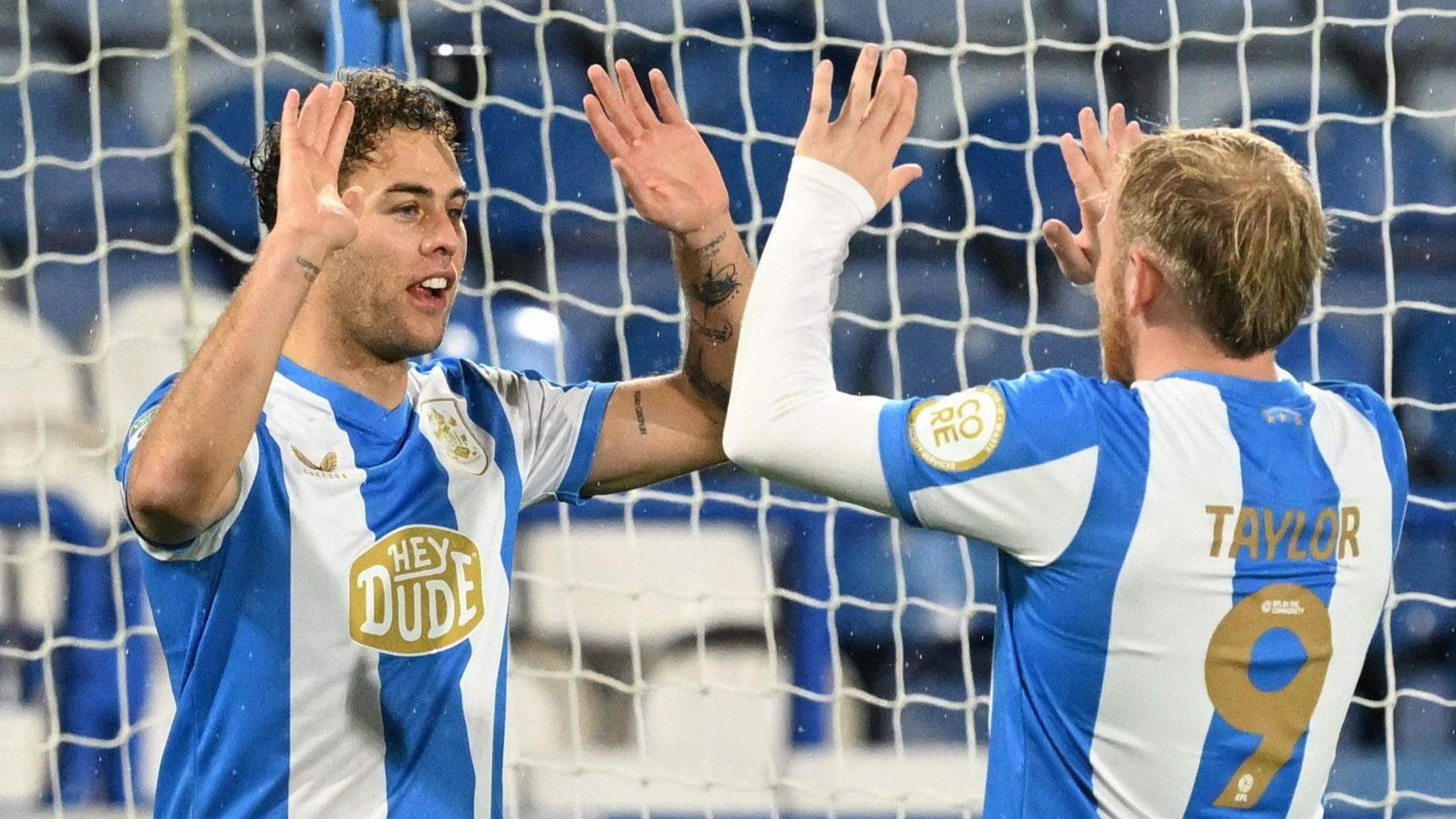 Huddersfield's Dion Charles (L) celebrates a goal