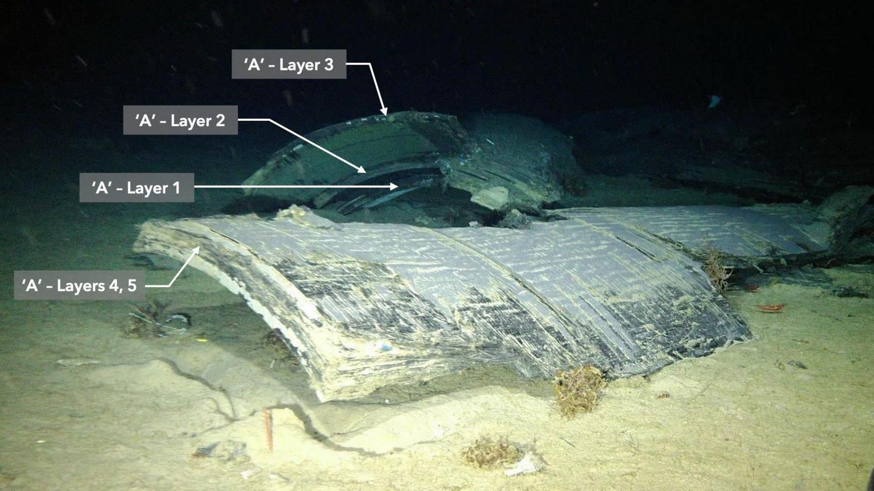 Wreck of submersible on seabed showing carbon fibre layers exposed
