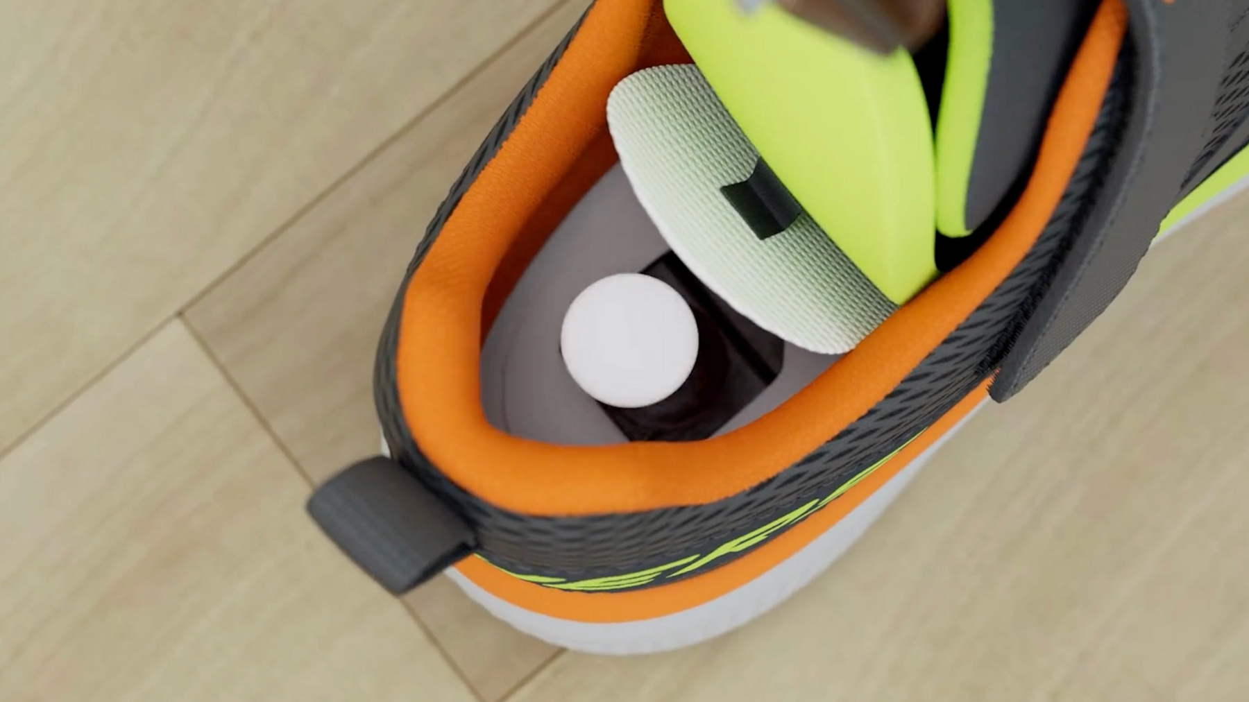 The shoe is shown with the hidden compartment open to illustrate where the AirTag would be placed
