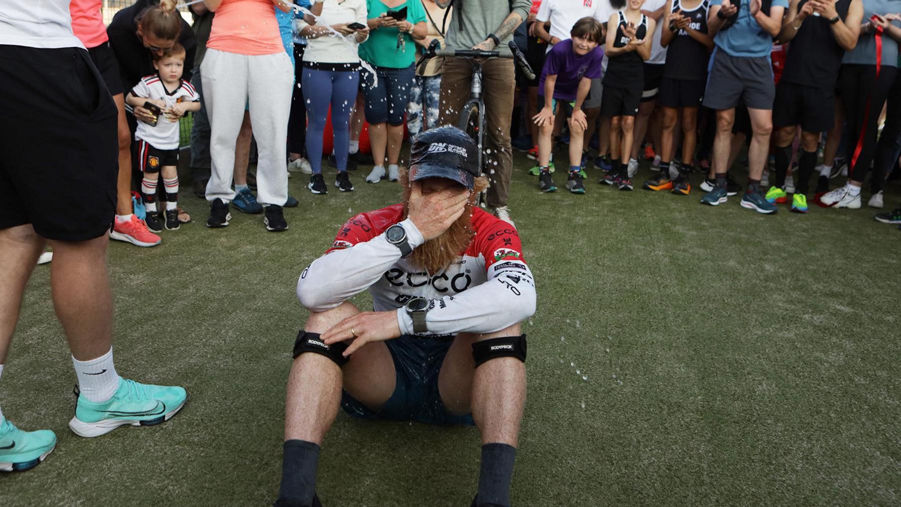 Sean Conway on floor with face in hands after 102nd ultra endurance marathon