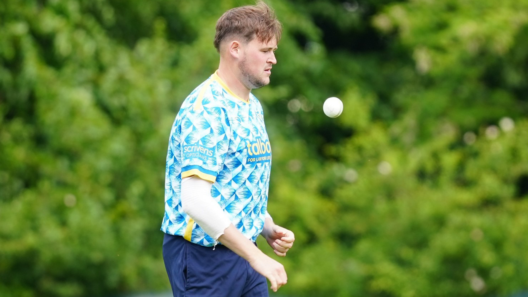 Adam Sylvester throws himself a catch as he prepares to start his run-up during a T20 game for Warwickshire
