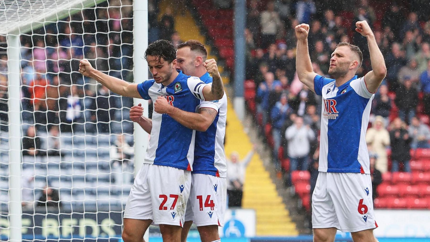 Lewis Travis celebrates scoring with his Blackburn teammates