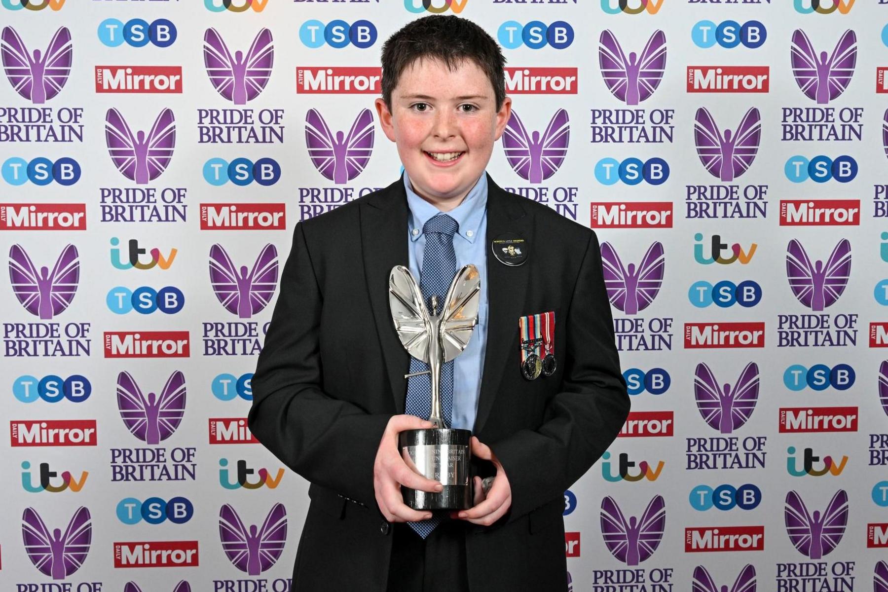 Jack holding his Pride of Britain award