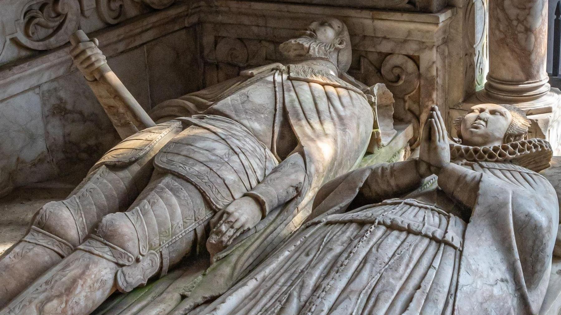 Grey effigies of a man and a woman lying on their backs