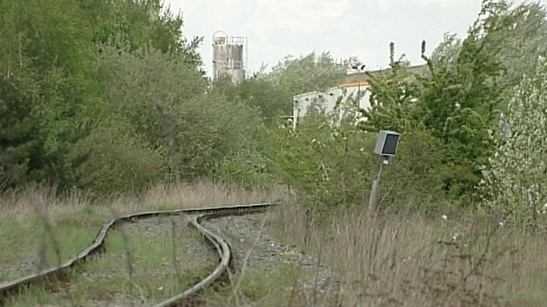 Part of the abandoned steelworks, with a railway line running through it.