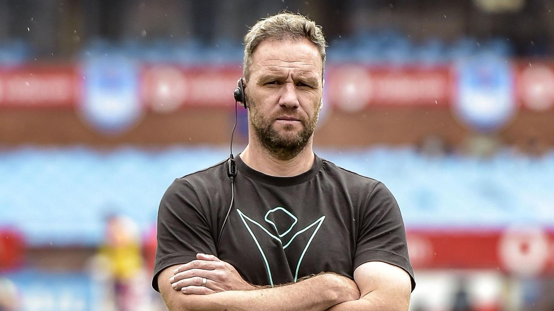 Mark Jones standing with his arms folded