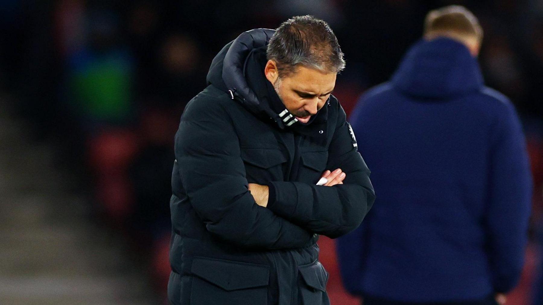 Marti Cifuentes looks dejected on the sideline