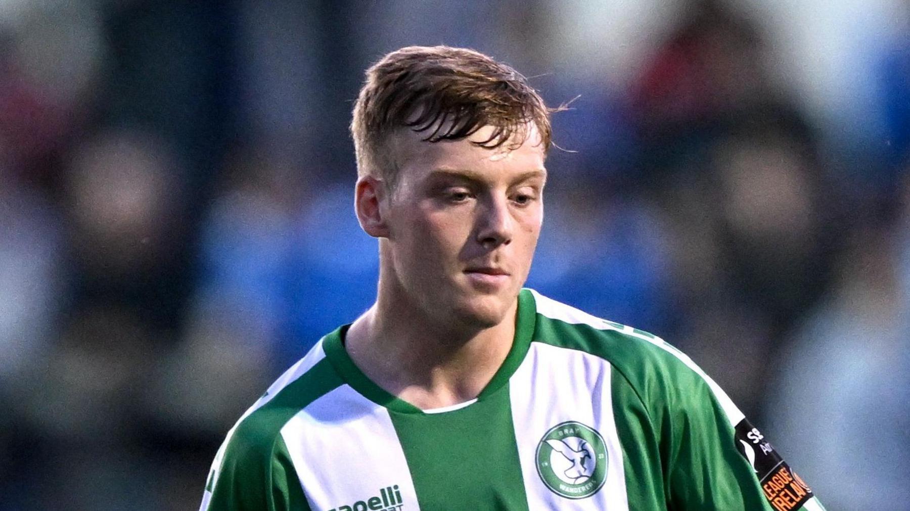 Cian Doyle playing for Bray Wanderers in a green-and-white-striped kit