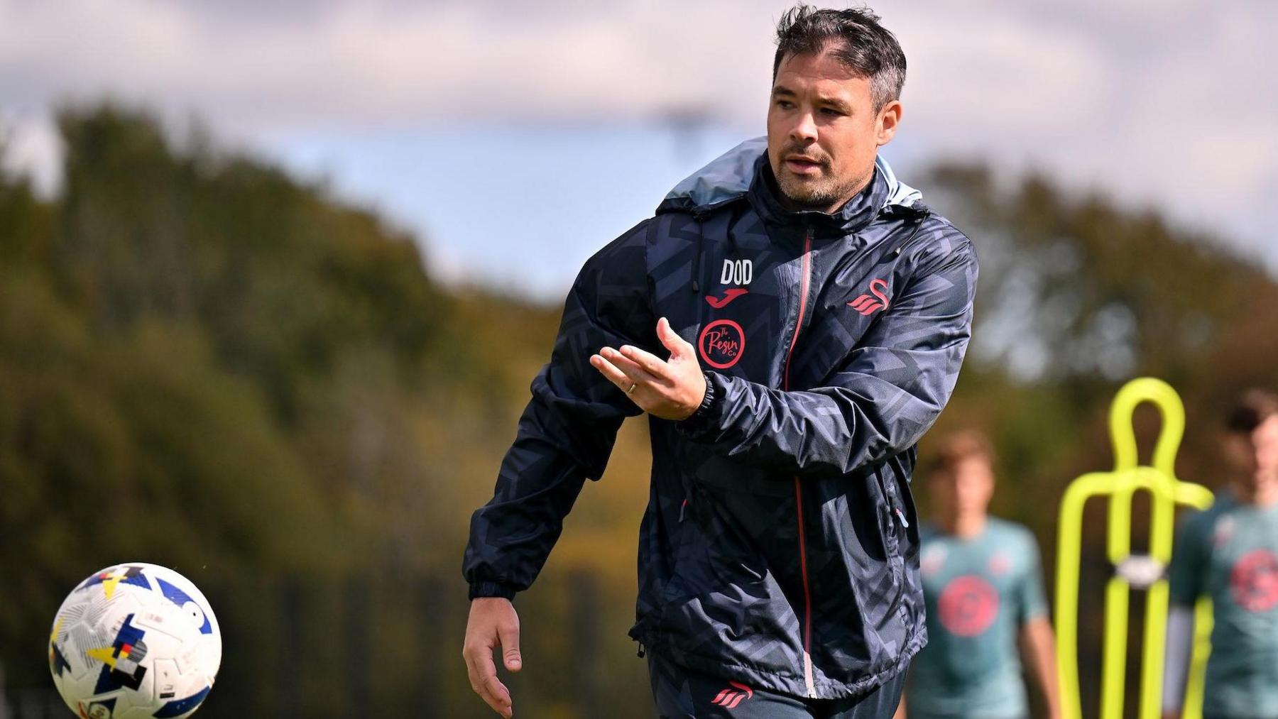Darren O'Dea throws a ball during Swansea training 