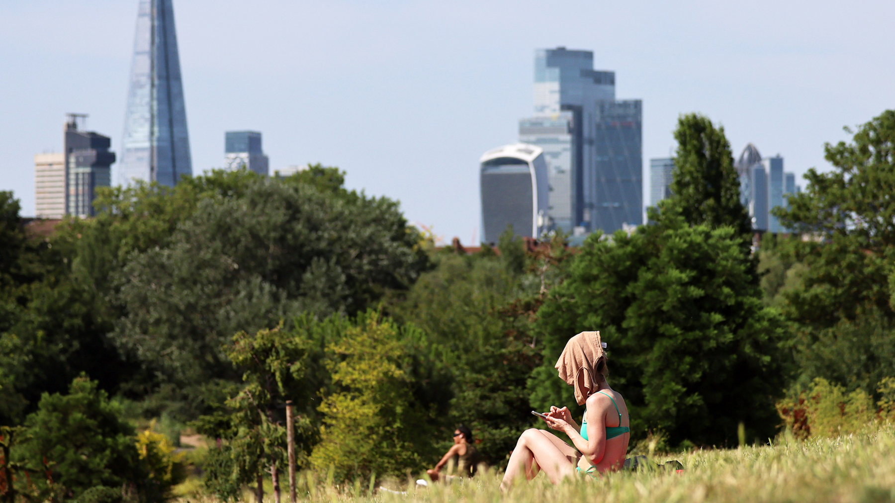 Mandatory Credit: Photo by ANDY RAIN/EPA/Shutterstock (16956441f)
A person covers her face from the sun at a park as the UK is set to experience its hottest June day on record during a heatwave in London, Britain, 23 June 2026. 