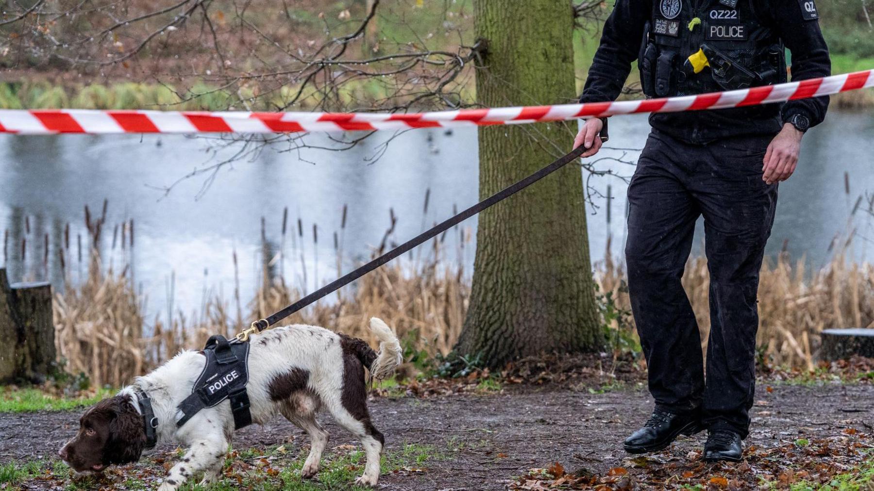 A police officer and dog at Oakwood Pond in Harlow