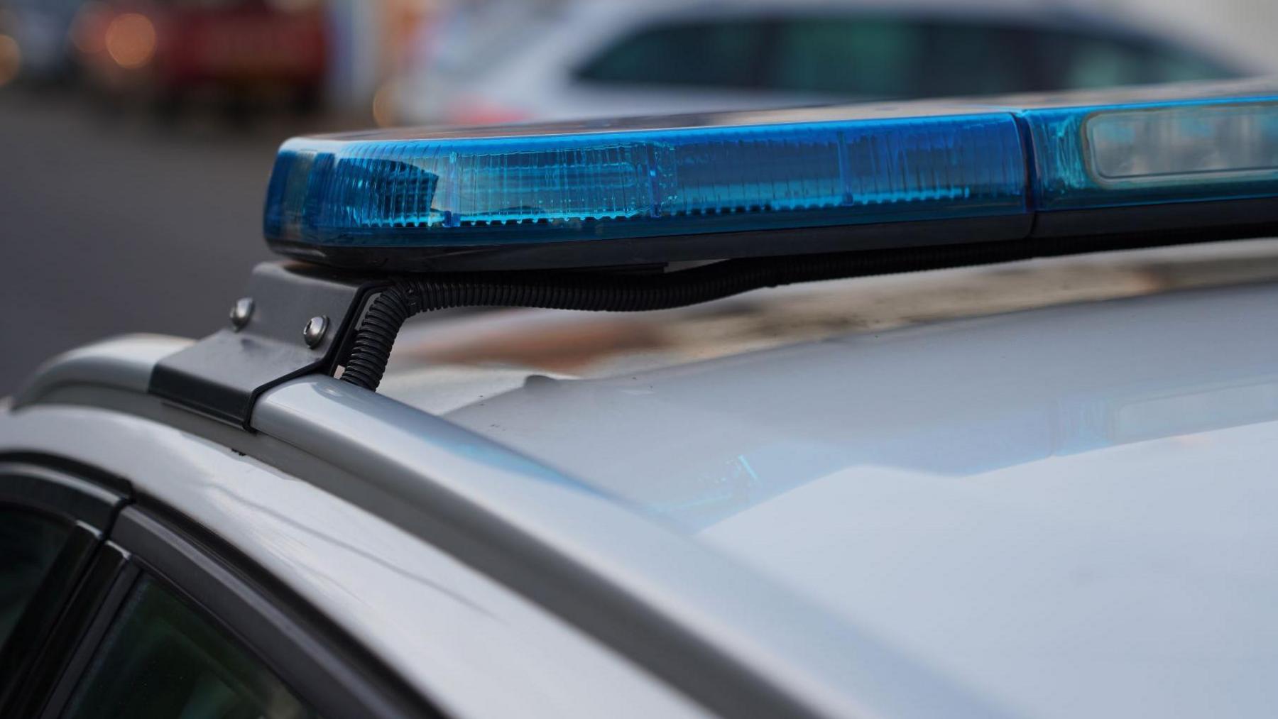 The blue lights on a police vehicle. Stock image.