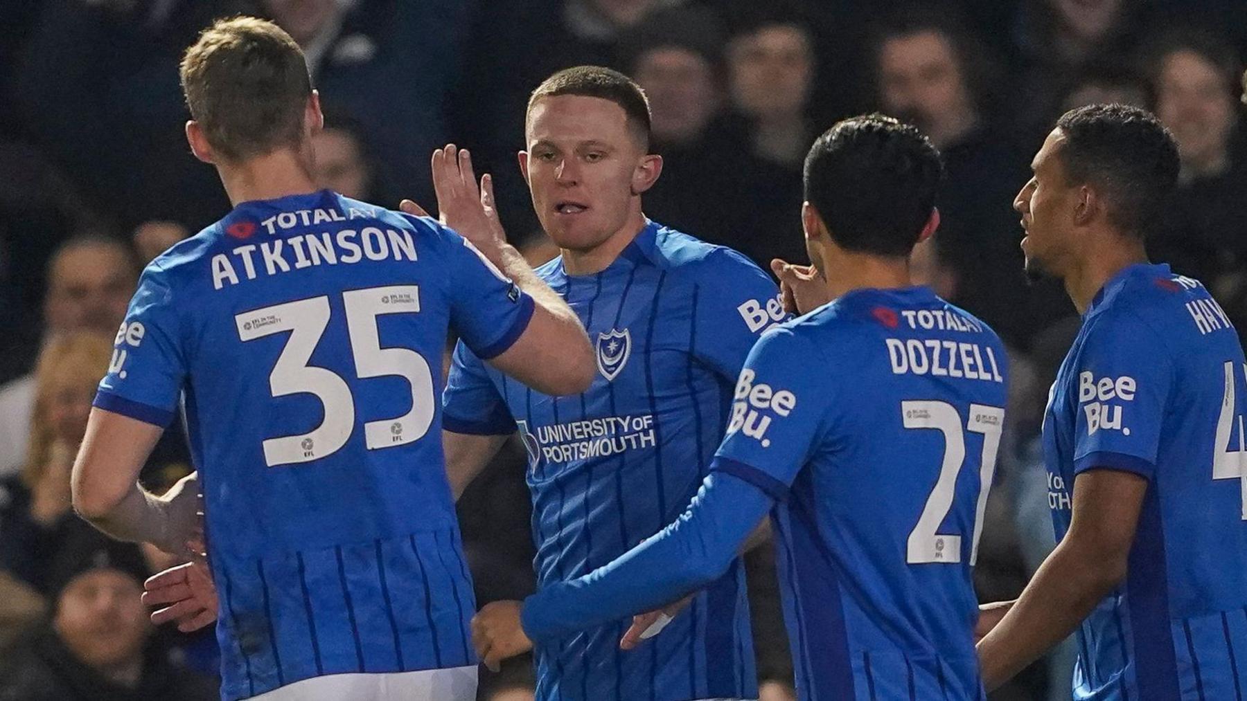 Colby Bishop (second left) celebrates scoring Portsmouth's opening goal