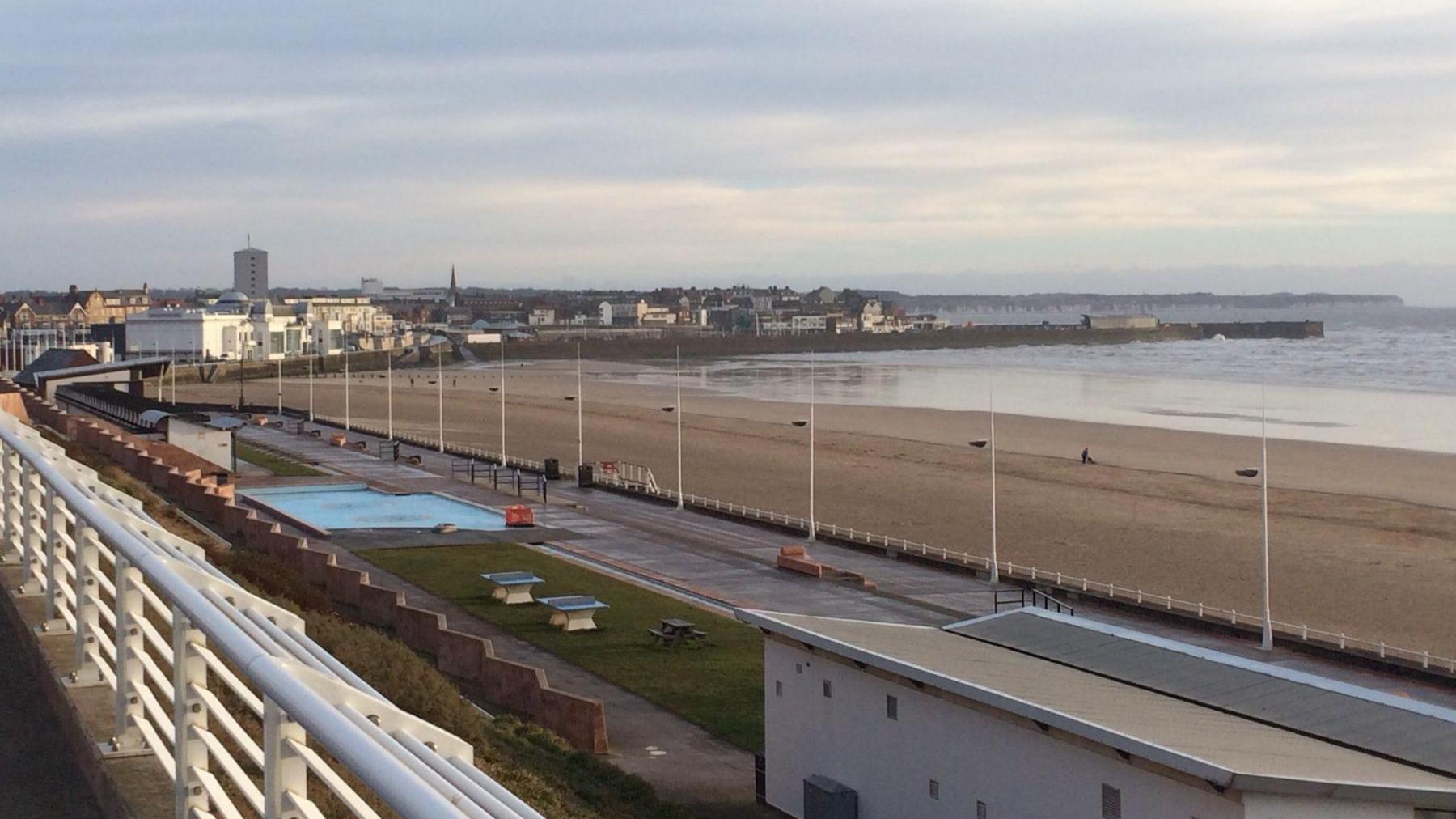 Bridlington South Beach from a distance. The town can be seen in the background with the beach and the sea towards the right of the picture. 