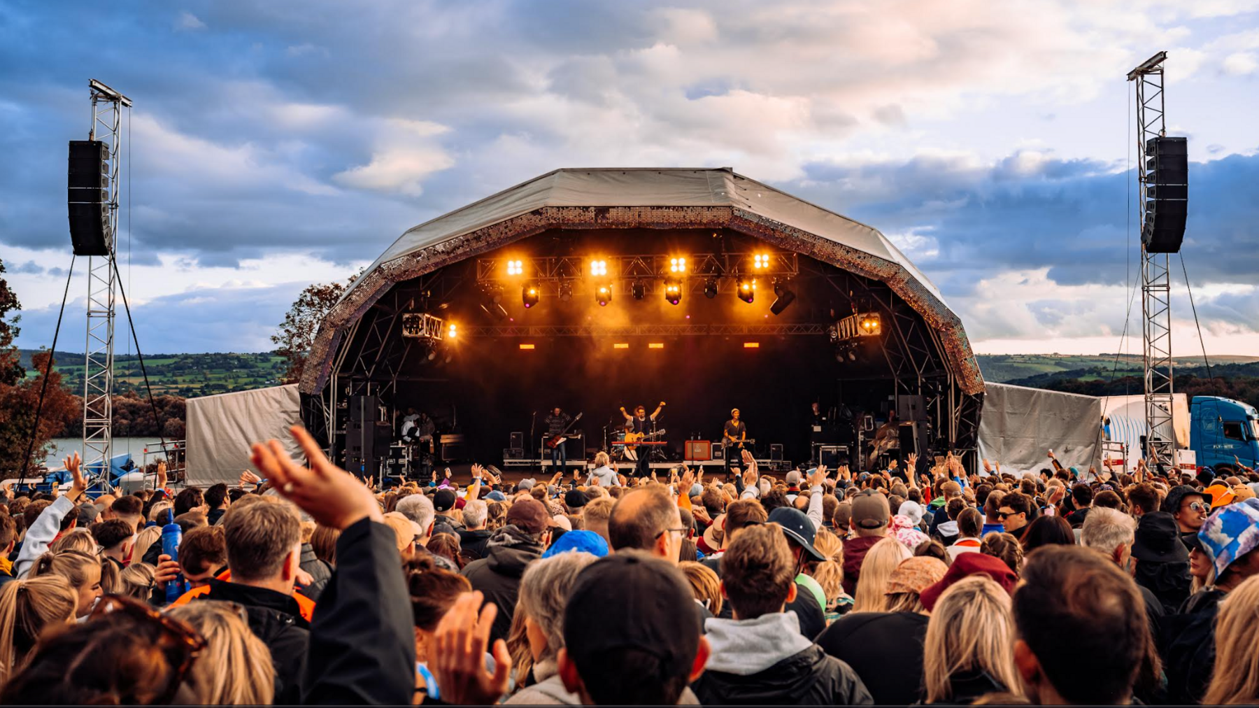 A crowd of people watching a band perform on the main stage