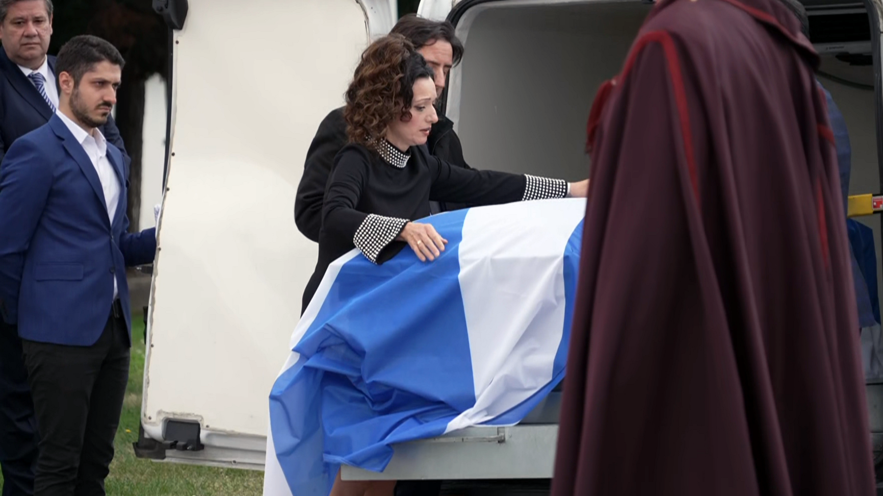 Tasmina Ahmed-Sheikh drapes a saltire over the coffin of Alex Salmond