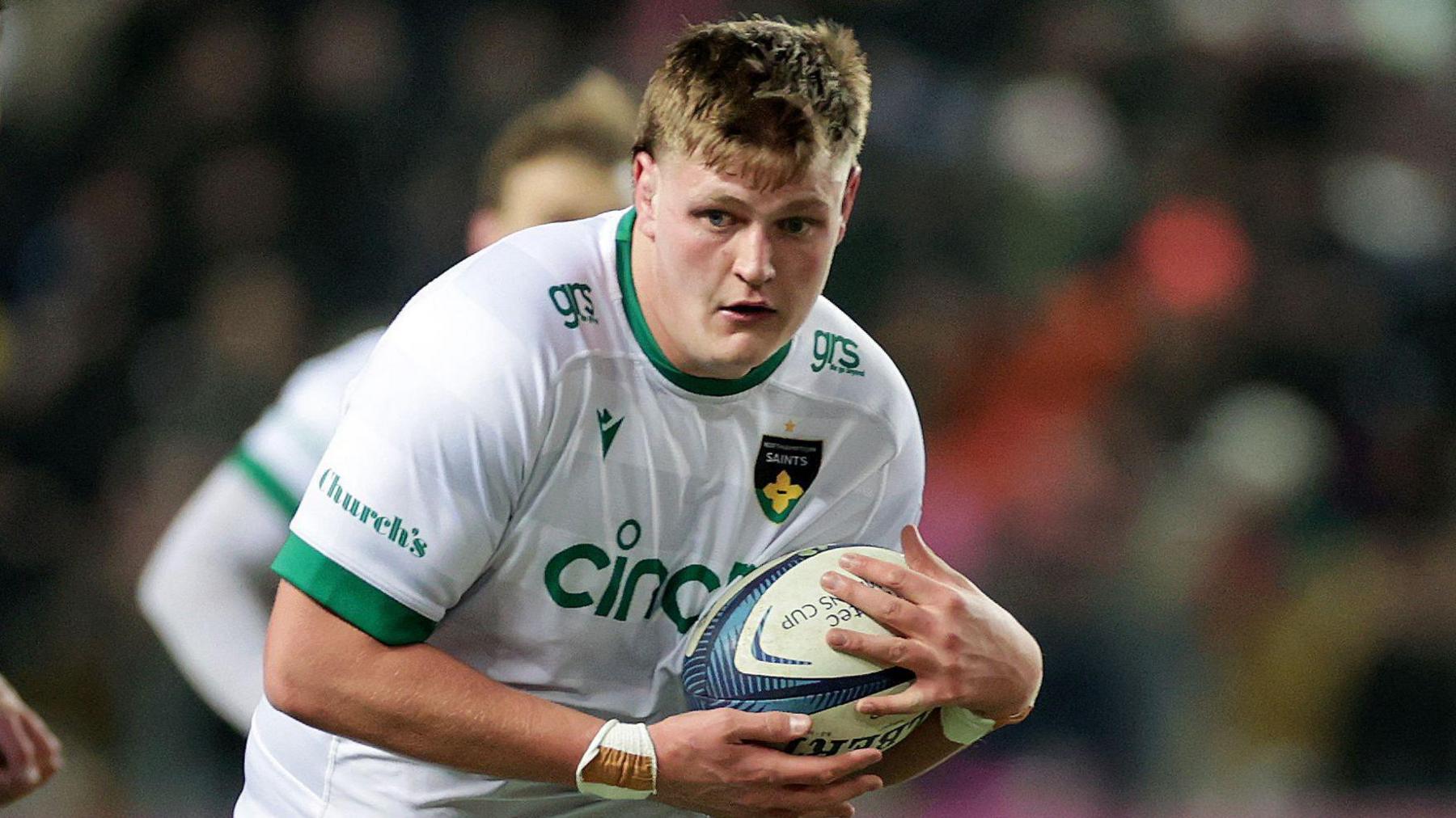 Ed Prowse carries the ball forward for Northampton Saints during a match 